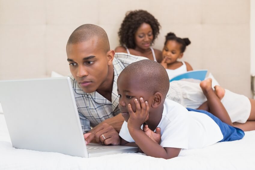 Happy family spending time together on bed